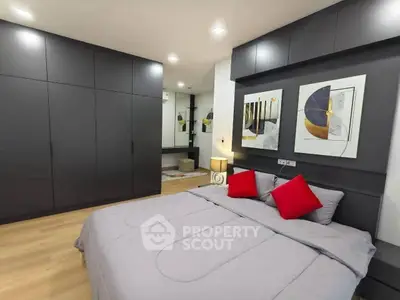 Modern bedroom with sleek dark wardrobes and stylish decor