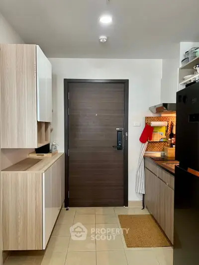Modern kitchen with sleek cabinetry and black appliances, featuring a closed layout and stylish design.