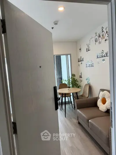 Charming living room with cozy decor and natural light, perfect for relaxation and entertaining.