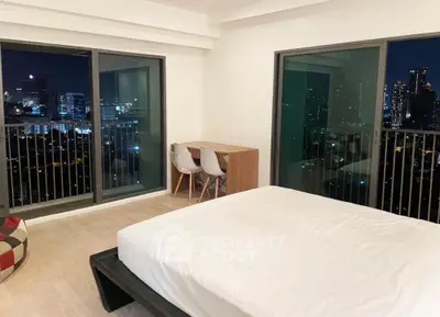 Spacious bedroom with stunning city view and modern furnishings