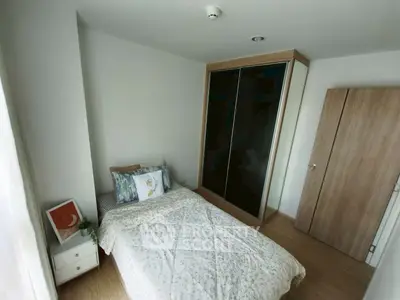 Cozy bedroom with modern wardrobe and stylish decor in a bright apartment.