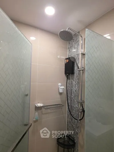 Modern bathroom with glass shower enclosure and rainfall showerhead