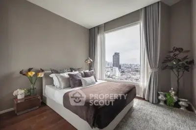 Luxurious bedroom with city view, elegant decor, and large window in modern apartment.