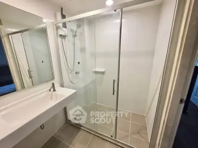 Modern bathroom with sleek shower enclosure and elegant sink design