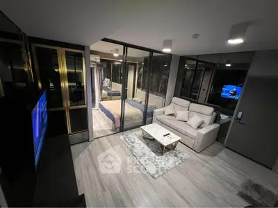 Modern living room with glass partition, cozy sofa, and stylish decor in a contemporary apartment.