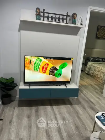 Modern living room with mounted TV and stylish decor, showcasing cozy ambiance and contemporary design.