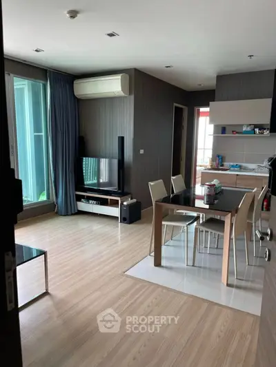 Modern living room with dining area and sleek kitchen design