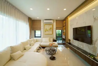 Luxurious modern living room with elegant decor and large windows for natural light.