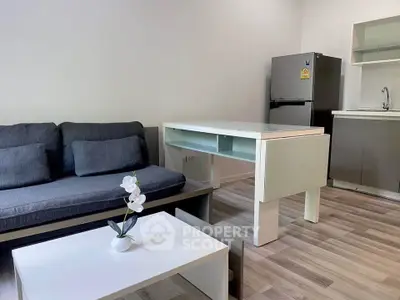 Modern living room with sleek furniture and open kitchen layout