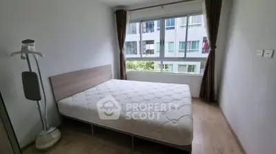 Bright bedroom with large window and modern decor