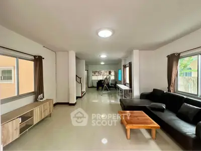 Spacious living room with modern furniture and ample natural light
