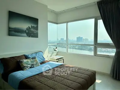 Modern bedroom with large windows offering stunning city and river views.