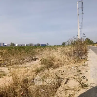 Expansive plot of land with development potential and clear skies.