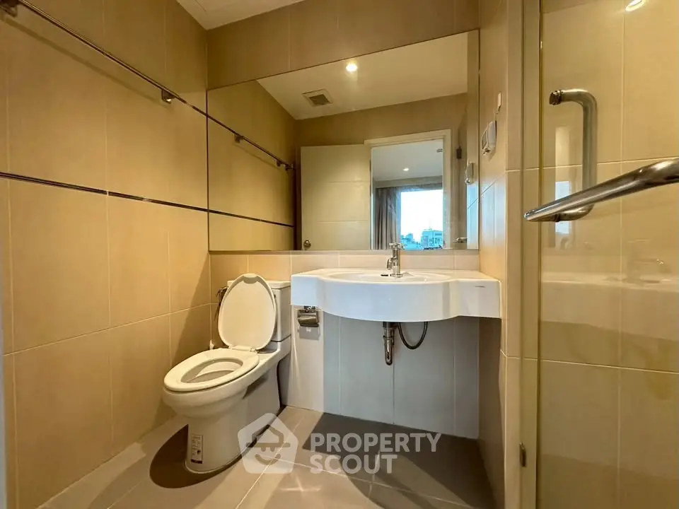 Modern bathroom with sleek fixtures and large mirror