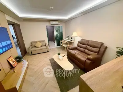 Cozy living room with modern furniture and ambient lighting, perfect for relaxation and entertainment.