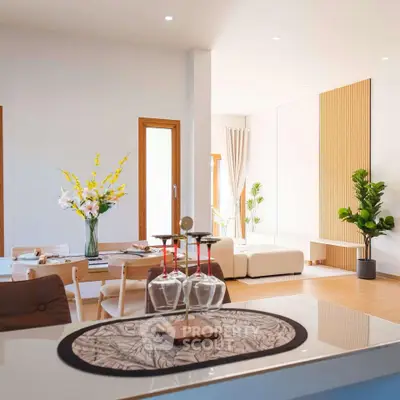 Modern open-plan living room with elegant decor and natural light