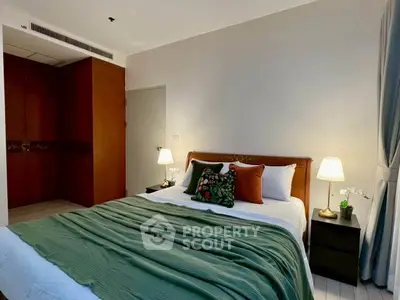 Cozy bedroom with stylish decor and ambient lighting in modern apartment.