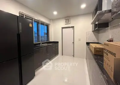 Modern kitchen with sleek black appliances and ample counter space