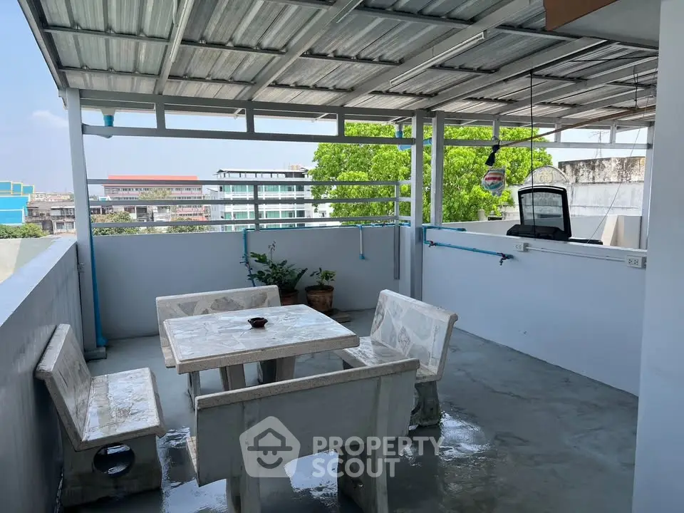 Charming rooftop terrace with seating area and city views, perfect for relaxation and gatherings.