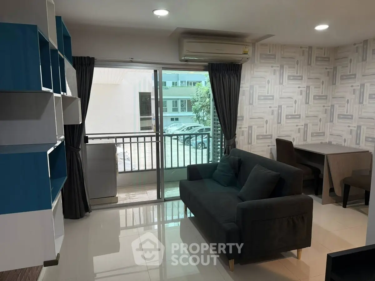 Modern living room with balcony access and stylish decor in a contemporary apartment.