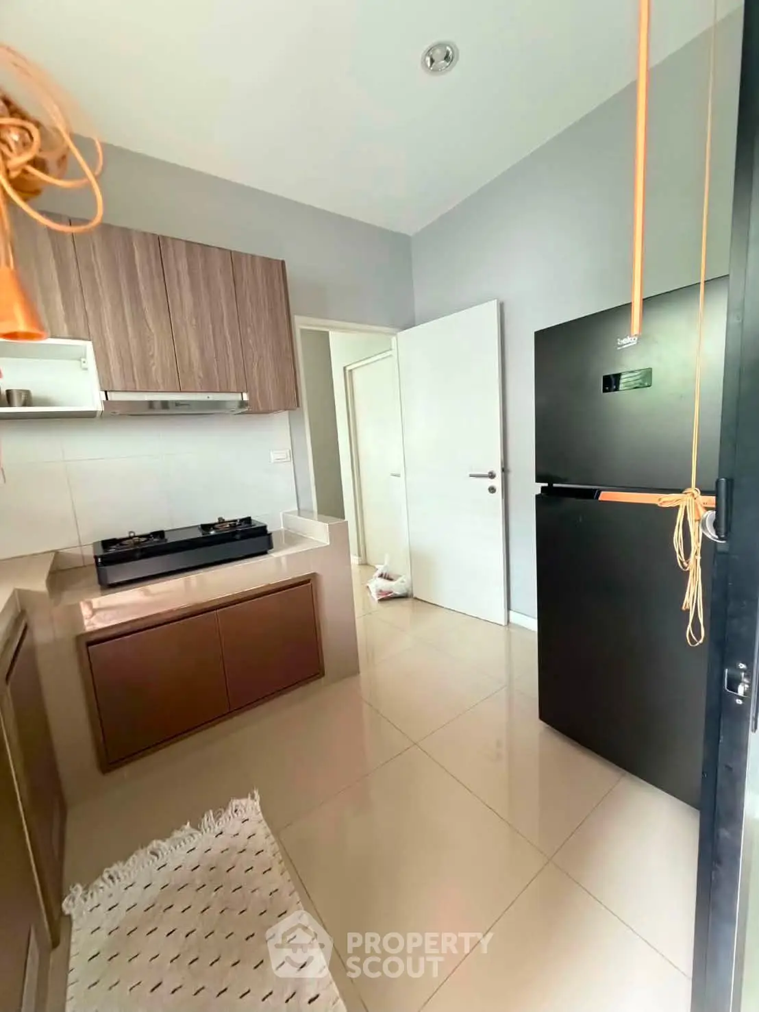 Modern kitchen with sleek cabinets and gas stove in a stylish apartment.