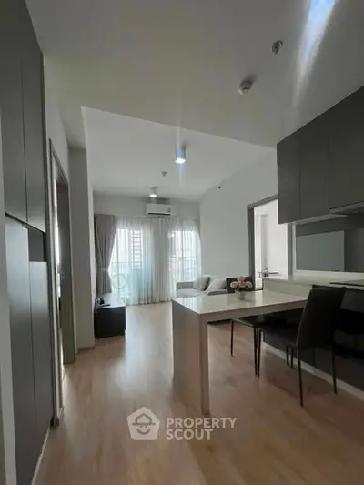 Modern open-plan living room with dining area and sleek kitchen design