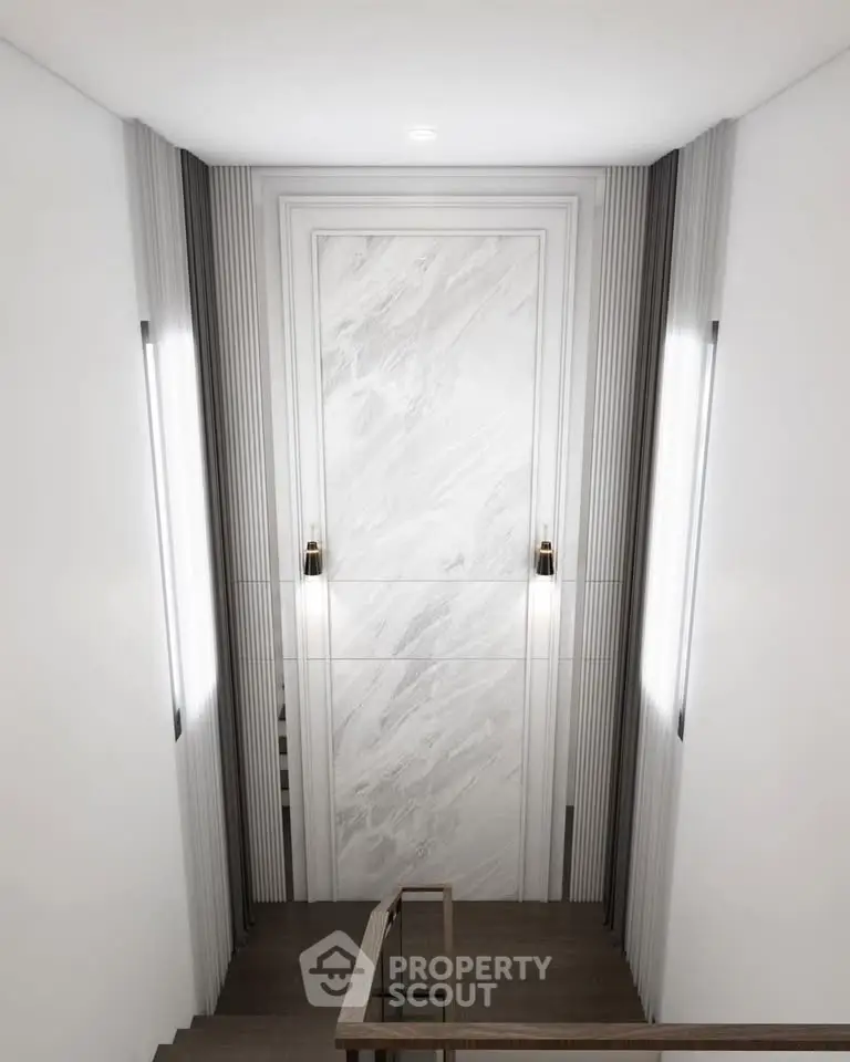 Elegant modern staircase with sleek lighting and marble wall accents in luxury building.