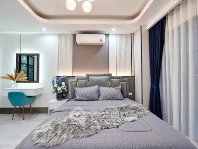 Luxurious modern bedroom with elegant decor and plush bedding in a stylish apartment.