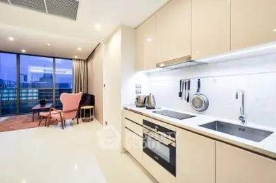 Modern open-layout kitchen with sleek appliances and spacious living area with city view.