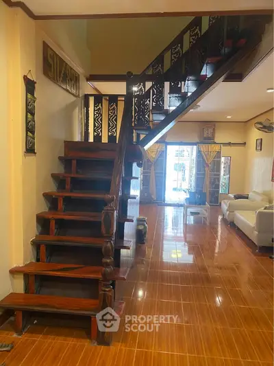 Charming living room with wooden staircase and elegant decor
