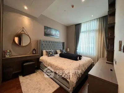 Luxurious bedroom with elegant decor and plush bedding in modern apartment.