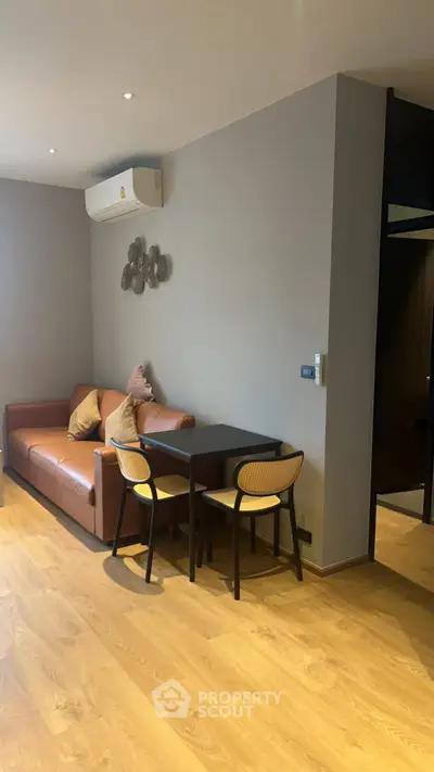 Modern living room with wooden flooring and cozy seating area