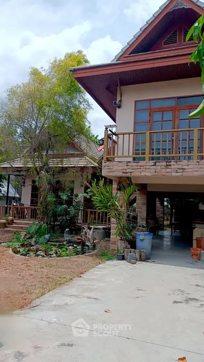 Charming two-story house with lush garden and spacious driveway, perfect for serene living.