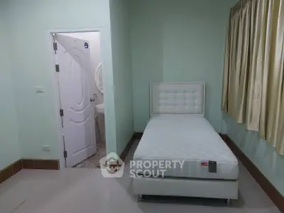 Cozy bedroom with single bed and attached bathroom in modern home