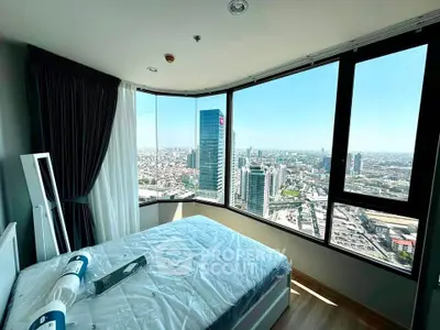 Stunning bedroom with panoramic city view in high-rise apartment