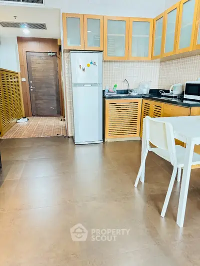 Modern kitchen with wooden cabinets and dining area in a cozy apartment