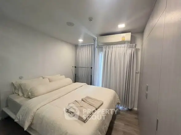 Cozy modern bedroom with soft lighting and elegant decor, featuring a comfortable bed and stylish curtains.