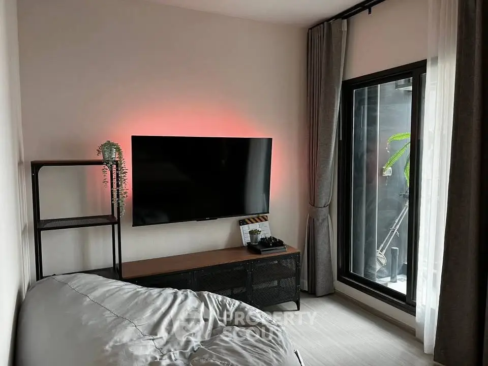 Modern living room with sleek TV setup and cozy bean bag seating