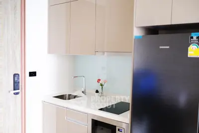 Modern compact kitchen with sleek cabinetry and stainless steel appliances