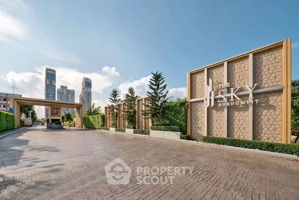 Luxurious entrance of The Sky Sukhumvit with modern architecture and lush greenery.