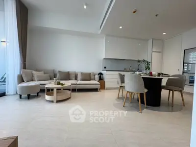 Modern open-plan living room with elegant dining area and stylish furnishings.