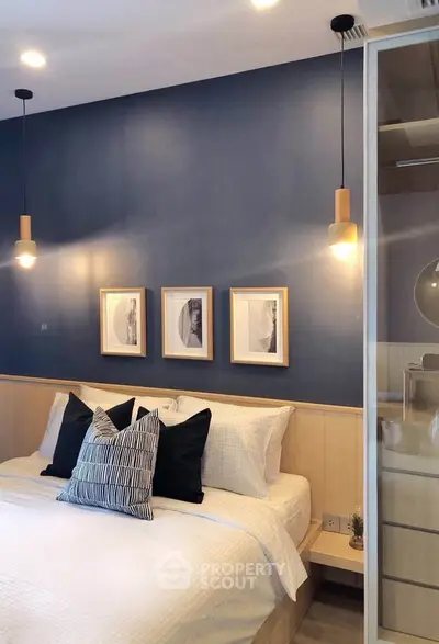 Stylish bedroom with modern decor and cozy lighting, featuring elegant wall art and plush bedding.