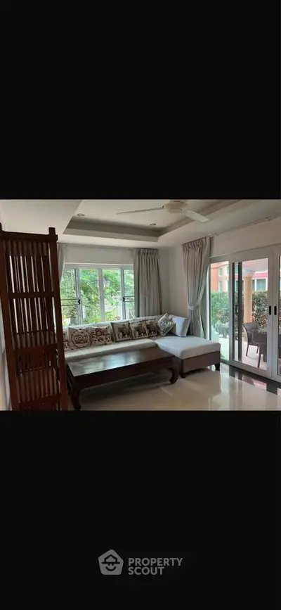 Spacious living room with large windows and elegant decor