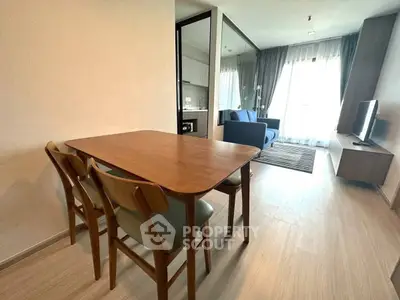 Modern open-plan living room with dining area and natural light