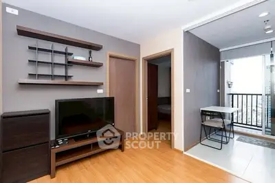 Modern living room with wooden flooring and balcony access in a stylish apartment.