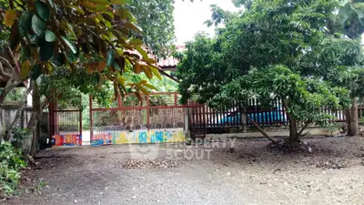 Charming gated entrance surrounded by lush greenery, perfect for privacy and tranquility seekers.