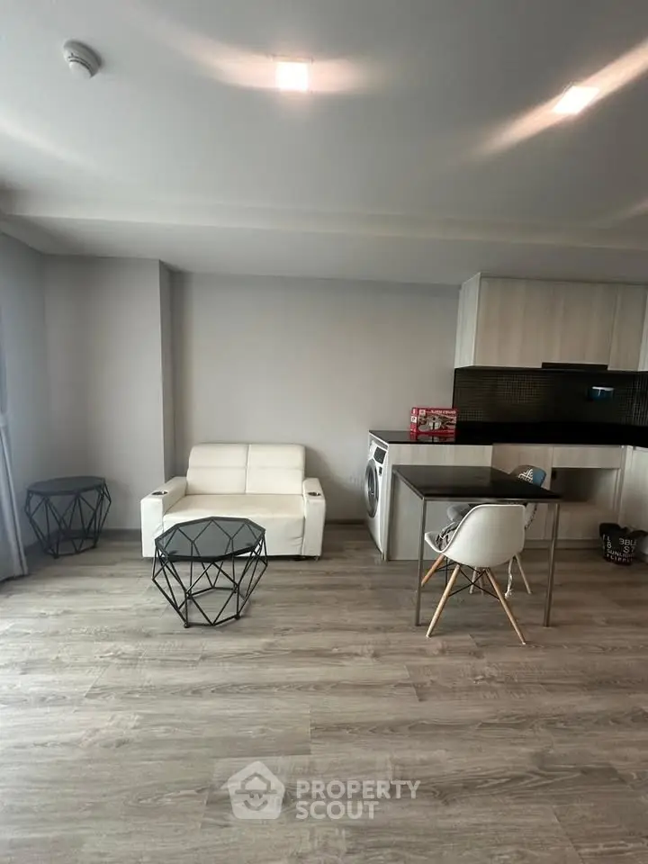 Modern living room with sleek furniture and integrated kitchen appliances