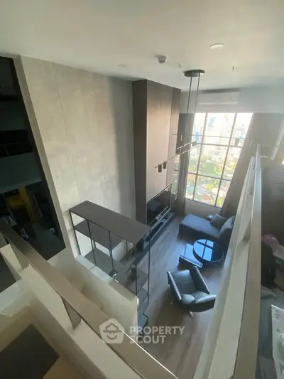 Luxurious modern living room with high ceilings and large windows offering stunning city views.