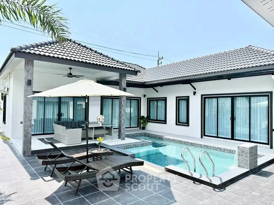 Luxurious modern villa with private pool and stylish outdoor seating area.