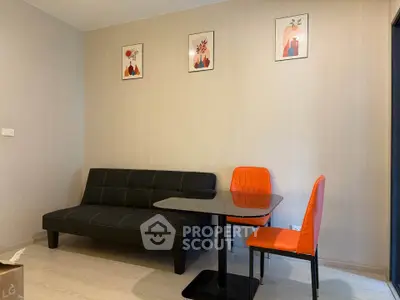 Modern living room with stylish sofa and vibrant orange chairs